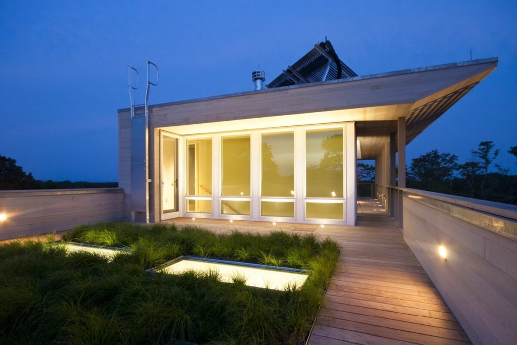Exterior of a modern modular home, showcasing its innovative design by Resolution 4 Architecture. This prefab house on Fishers Island features a rooftop garden, blending seamlessly with its surroundings.