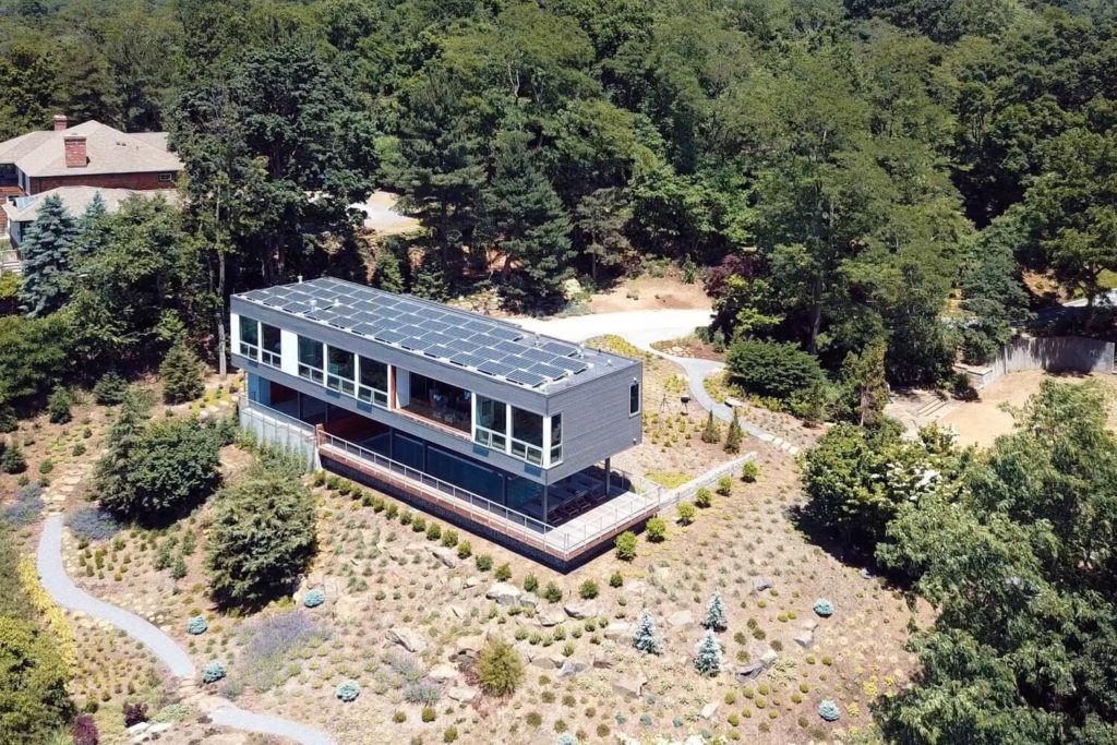 Aerial view of a modern modular home designed by Resolution 4 Architecture, known as the Hudson River House. This prefab residence showcases sleek lines and innovative design, offering a stunning perspective from above.